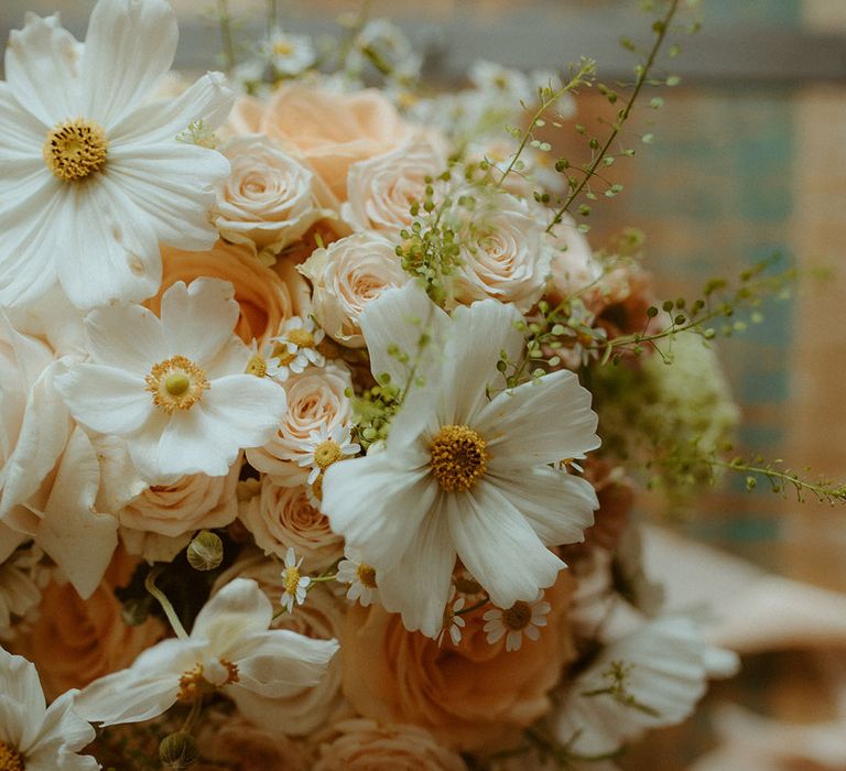 Pink roses, white cosmos and daisies in wedding bouquet 