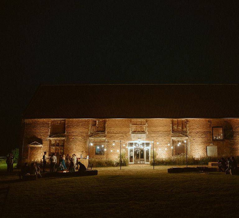 Godwick Barn wedding venue lit up by fairy lights 