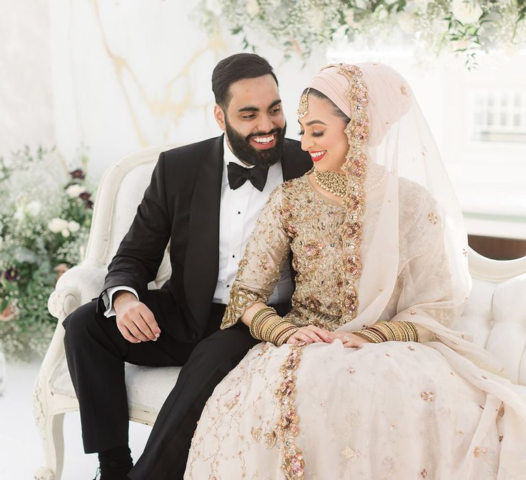 Bride & groom sit with one another at the Isla Gladstone Conservatory for Walima 