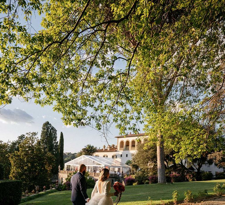 Bride & groom walk outdoors at the Villa Palmieri Florence