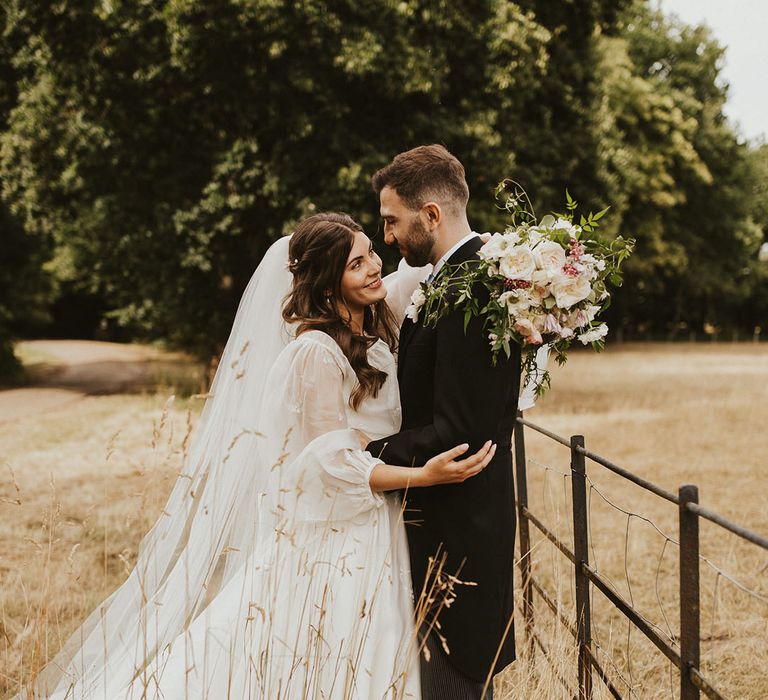 Bride and groom pose for cute couple portrais in the grounds surrounding Sprivers Mansion 