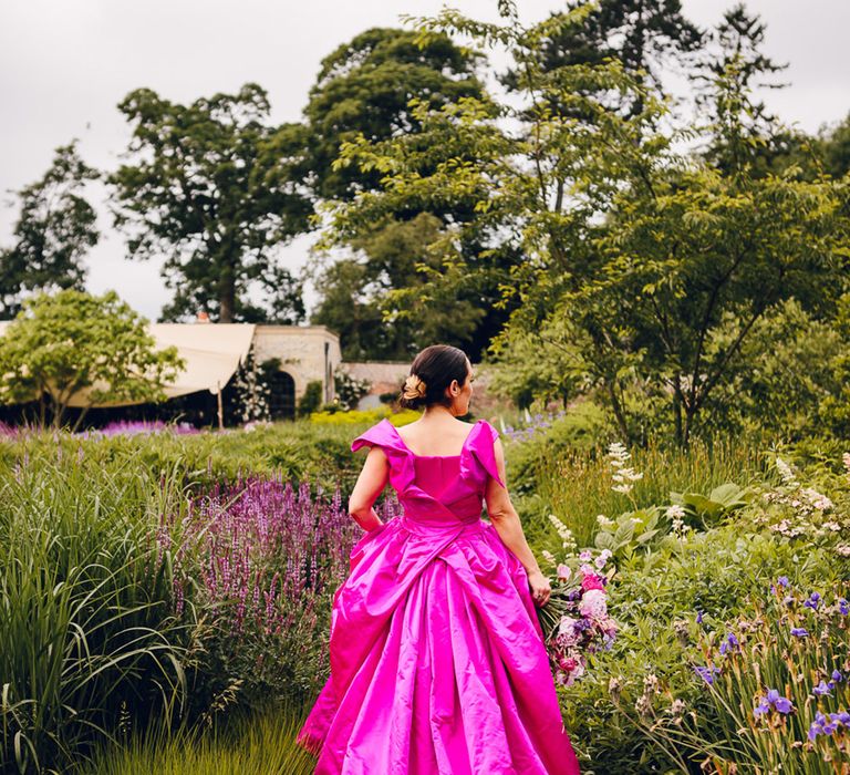 Bride in off the shoulder front ruching pink Vivienne Westwood wedding dress with ruching sleeve detail on the back 