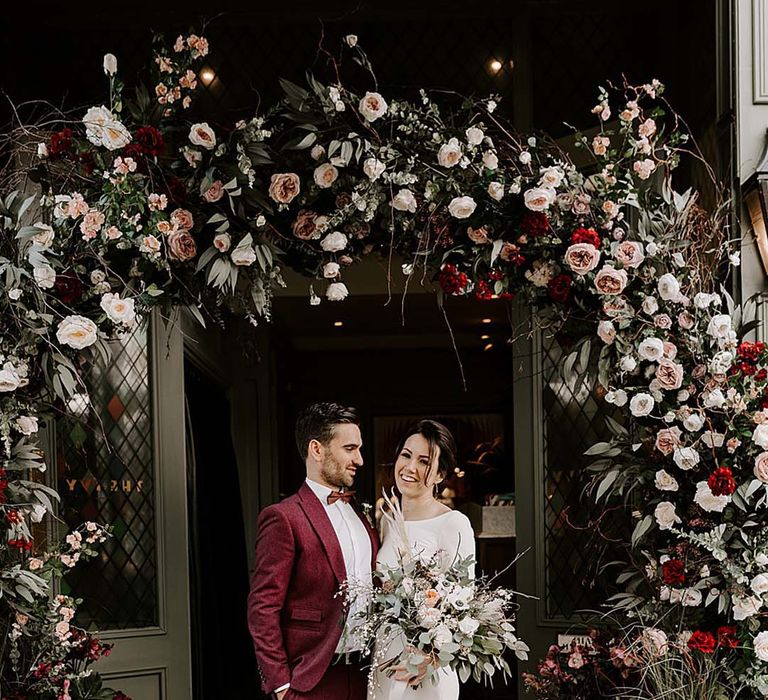 Romantic red, pink, and white rose flower arch for registry office wedding 