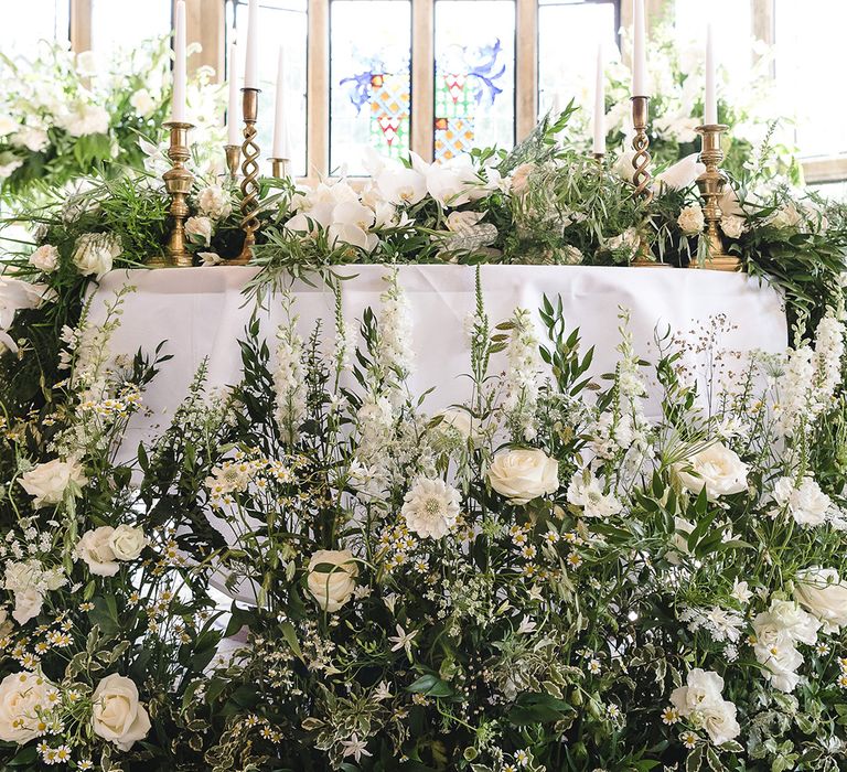 Extravagant wedding flowers with classic white and green colour scheme including roses and orchids 