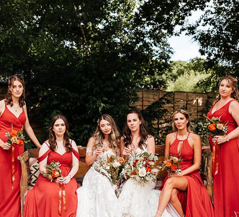 Lesbian wedding with large wedding party of bridesmaids in red dresses