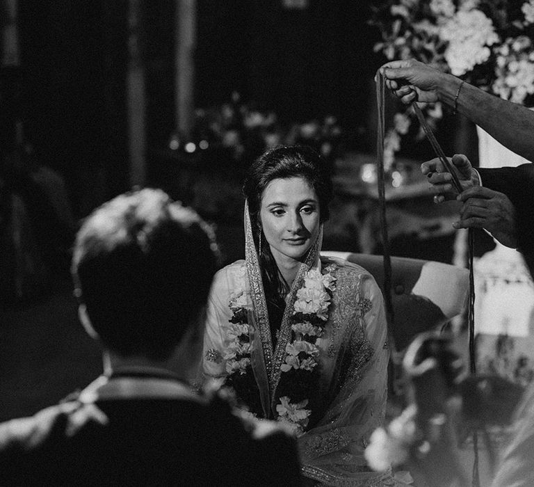 Bride wearing varamala for Hindu blessing at interfaith wedding 