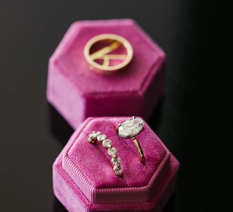 Hexagonal hot pink velvet ring box with oval engagement ring and spaced diamond wedding band 