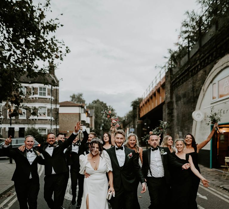 Wedding party wearing black tuxedos and black bridesmaid dresses for wedding party 