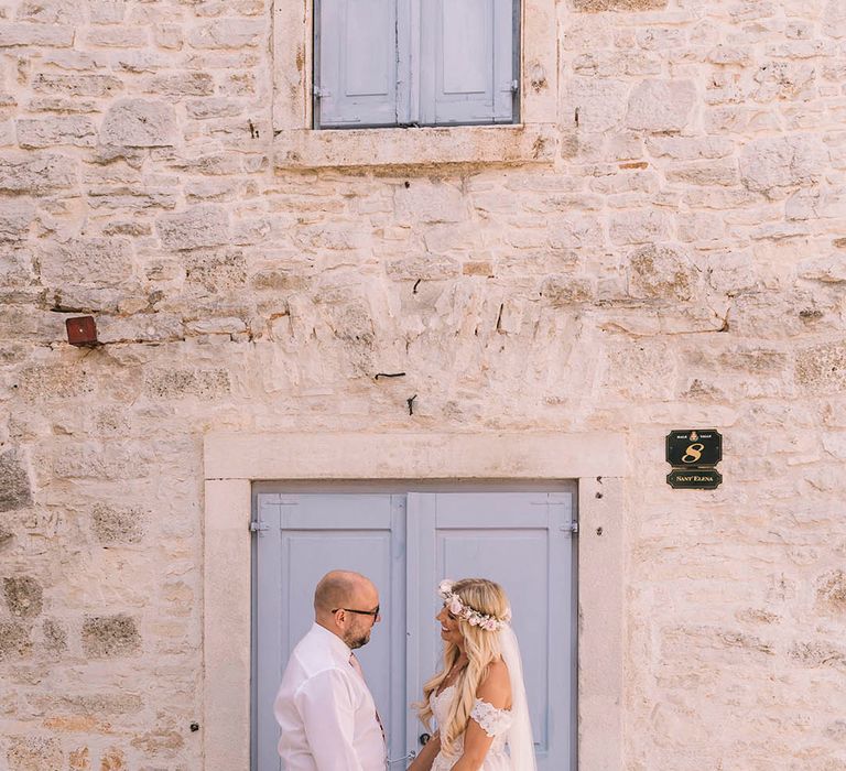 Couple portrait at Croatia destination wedding with pastel blue door 