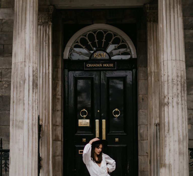 Bride in boots and fedora at town hall wedding 