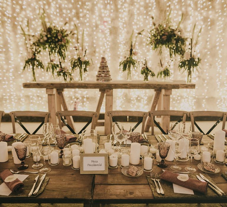 fairy light curtain and candles as industrial chic wedding decor