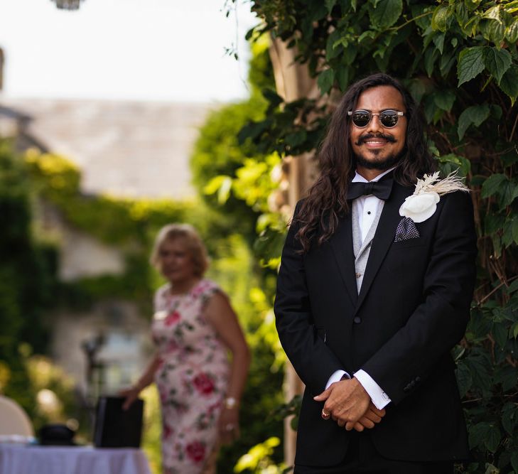 Groom at the altar in a black suit waiting for his bride 