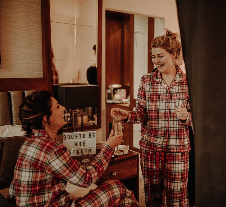 Bridal party wearing tartan matching pajamas for Christmas themed wedding