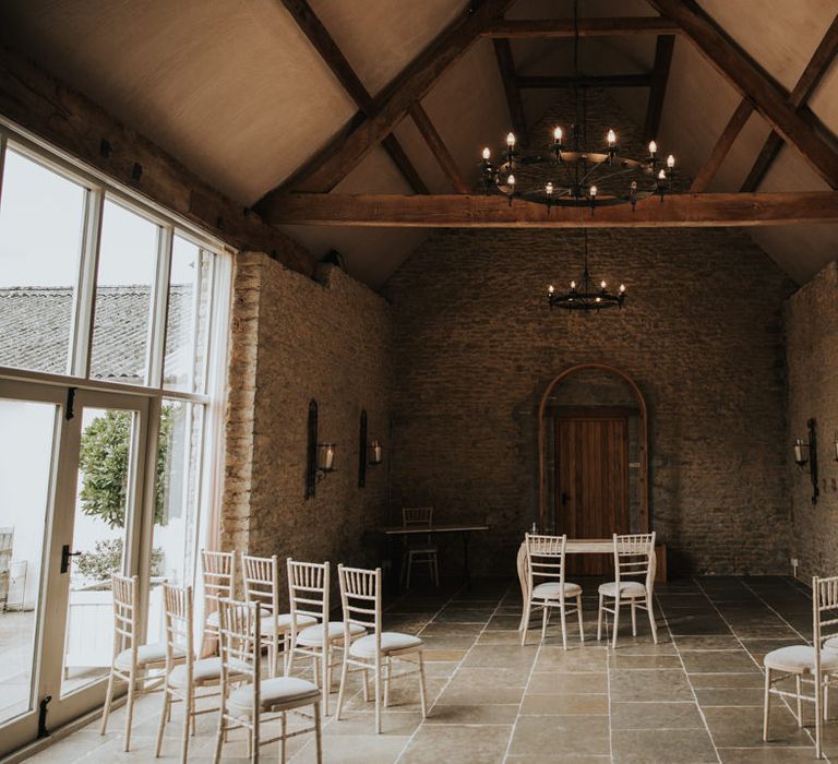 Barn wedding interior with rustic chairs