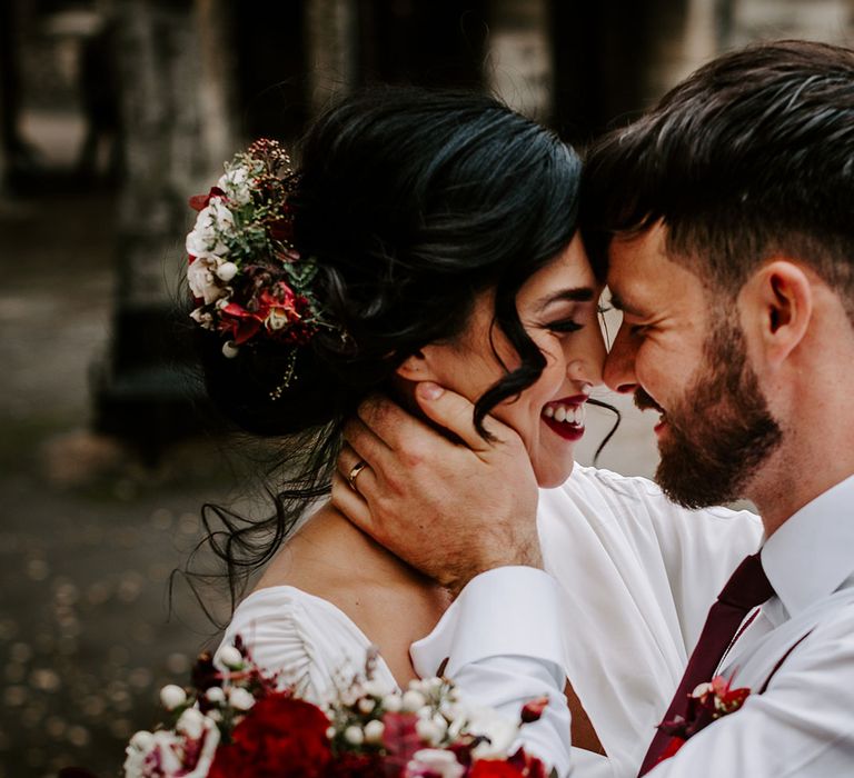 Smiling Bride with wedding hair updo with flowers and Groom