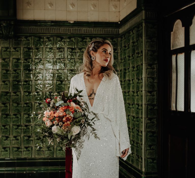 Bride in plunge neck dress with bouquet 