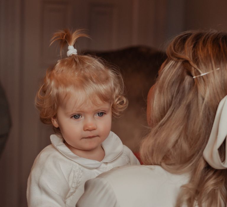 Flower girl being carried 