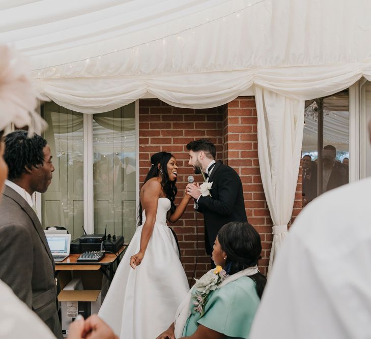 Bride and groom singing a duet 