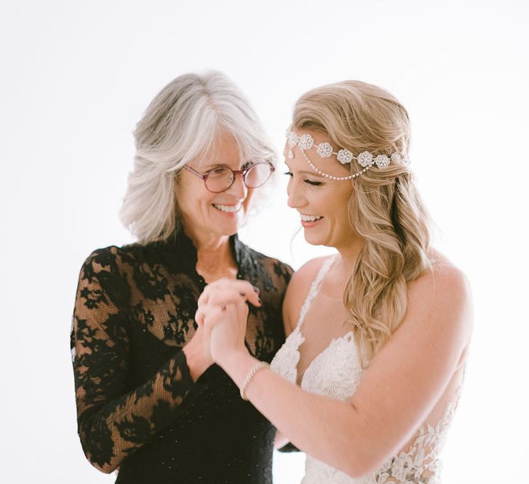 The bride and her mother share an intimate moment before the ceremony