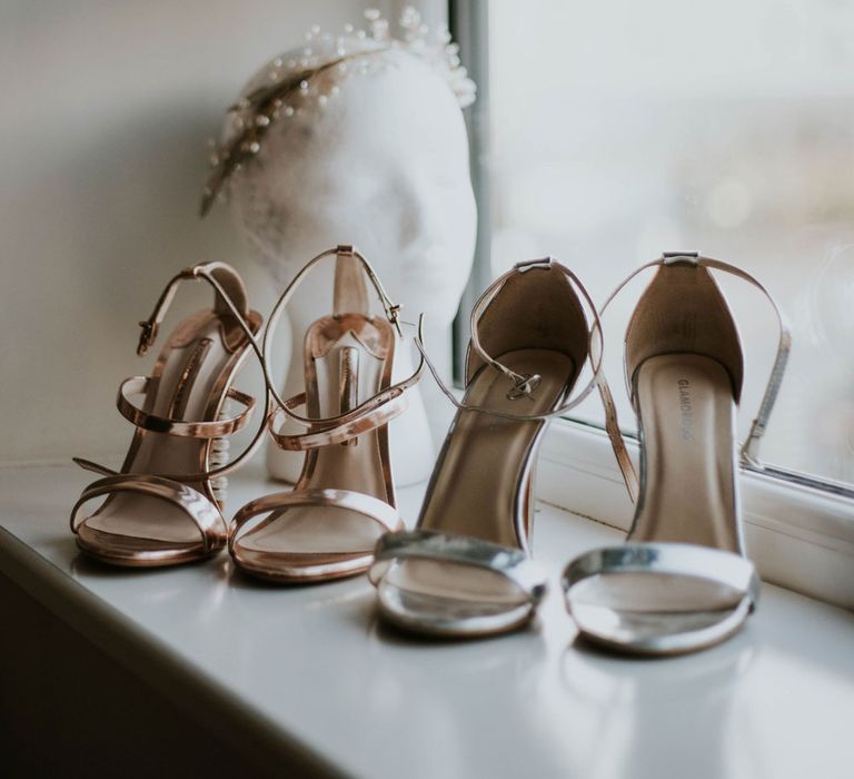 Silver and rose gold heeled sandals on a windowsill before wedding at Bridge Community Church