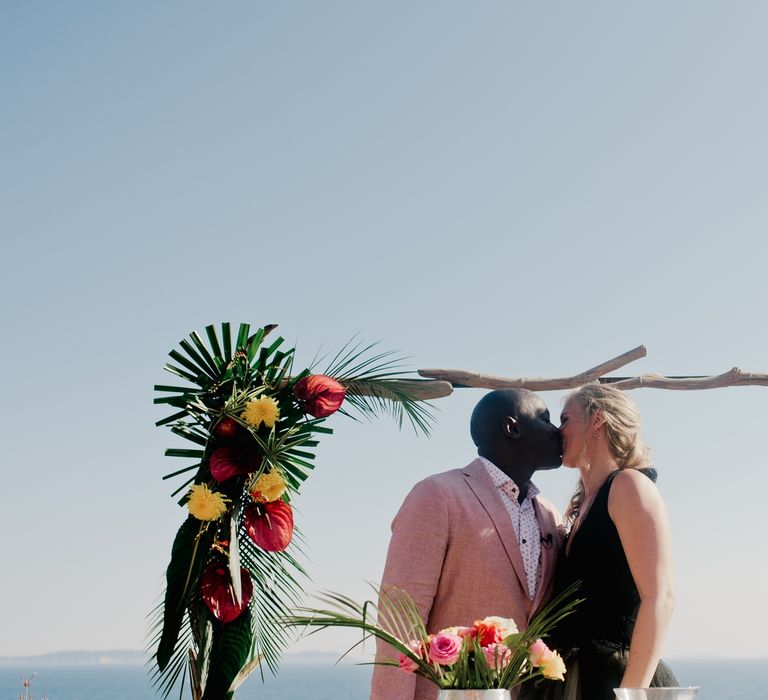 Bride in Vera Wang black wedding dress kisses new husband