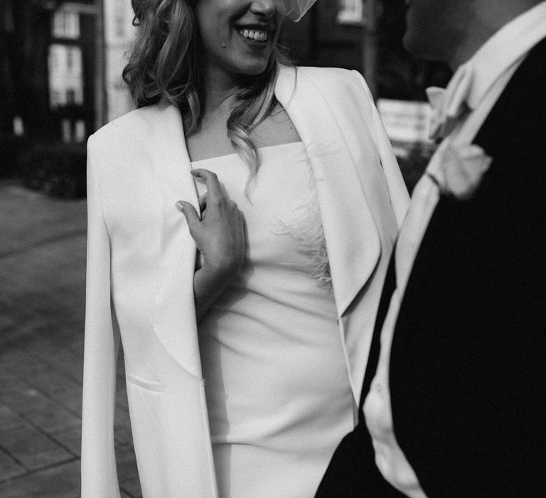 White wedding blazer - bride and groom holding one another