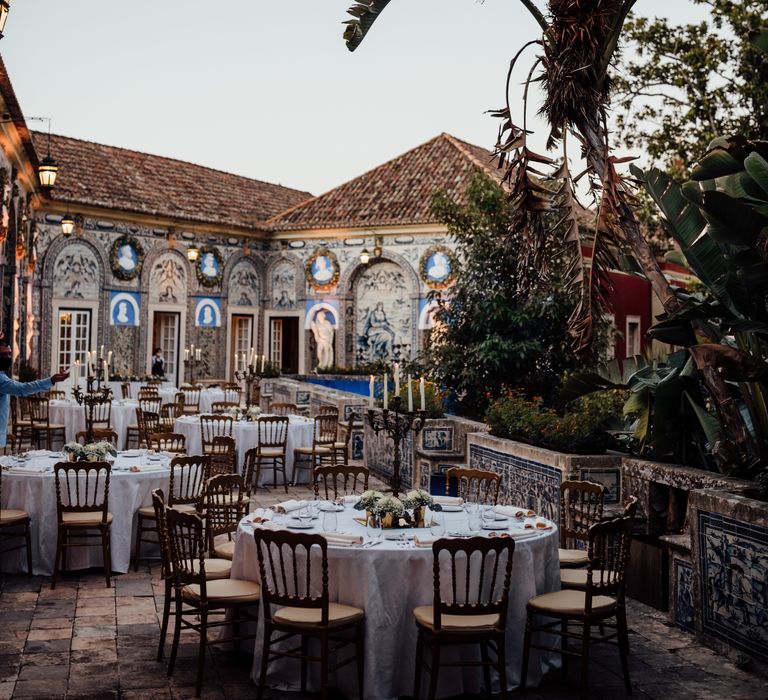 Colourful outdoor reception with classic tiling along the side and palm trees