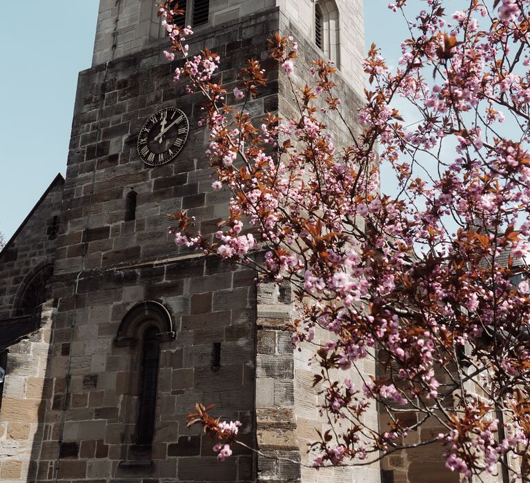 St Oswald's Church in Sowerby with pink tree blossom