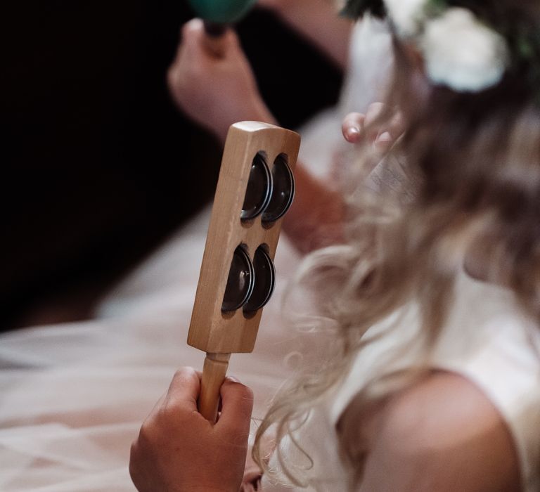 Flower girl with music shaker instrument for church hymns