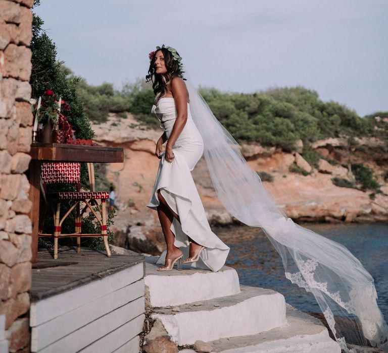 Bride walking to her romantic beachside wedding reception