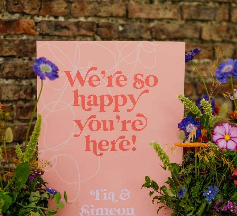 Vibrant "We're happy you're here" wedding welcome sign for fiesta theme wedding