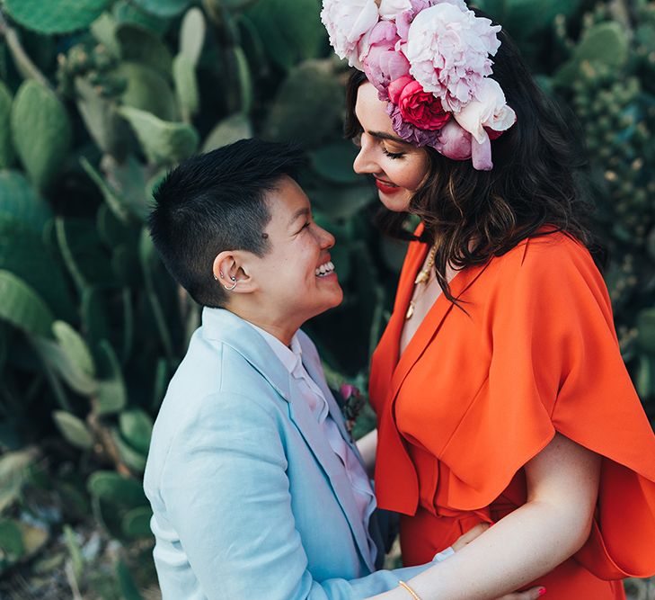 Brides look lovingly at one another during post-wedding photoshoot