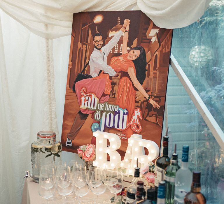 Retro style poster beside bar area for marquee wedding reception 