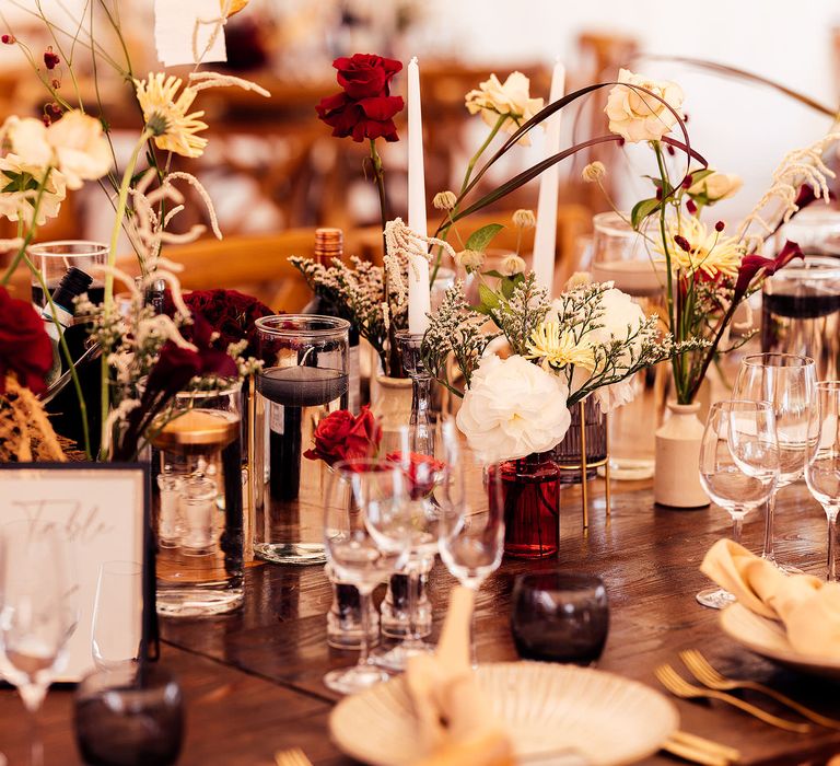 Beautiful red and cream wedding flower stems in small vases