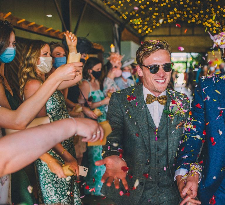 Grooms have confetti thrown around them on their wedding day | Story + Colour