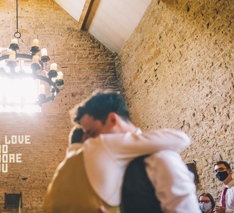 Grooms hug at Stone Barn wedding venue in the Cotswolds  | Story + Colour