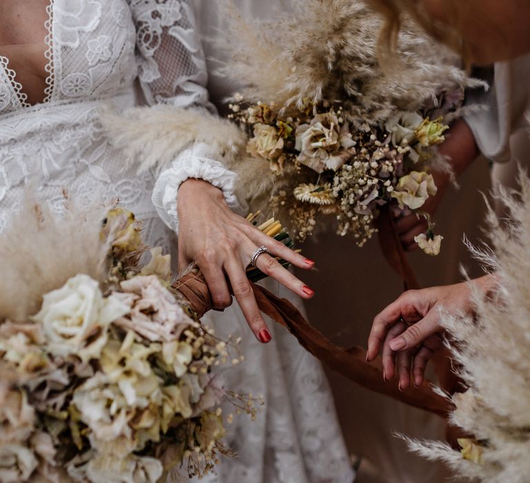 Bride has red nails for her wedding day as she shows rings to guests