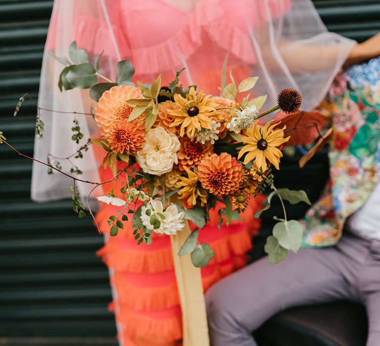 Yellow and orange wedding bouquet with dahlias and wildflowers 