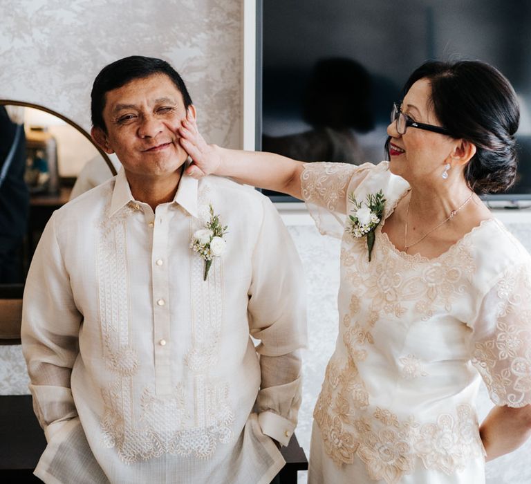 Mother and Father of the Bride in cream traditional elegant outfits 