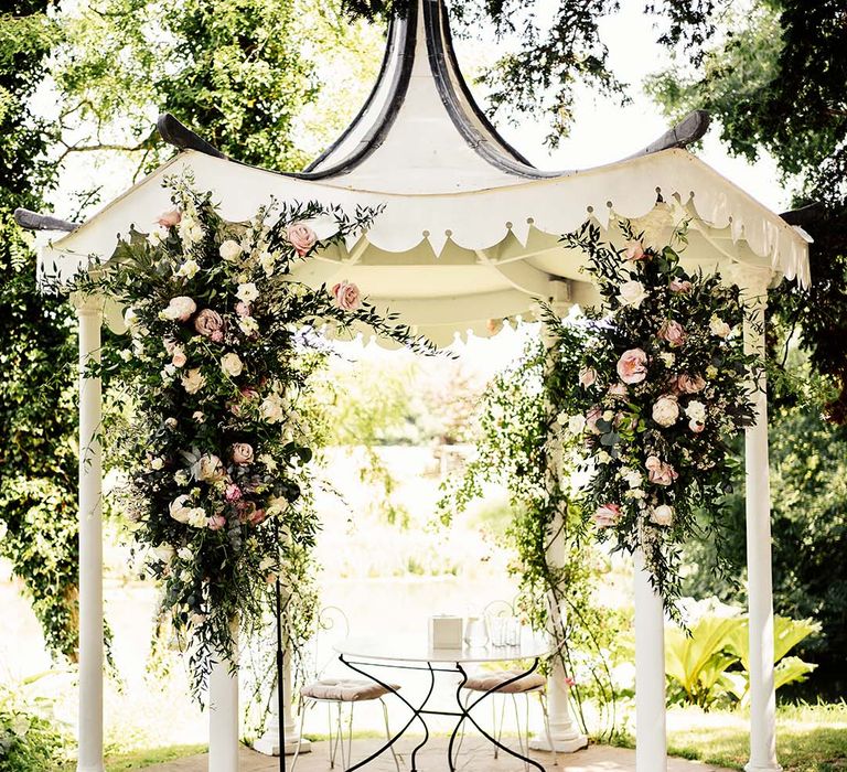 Beautiful outdoor wedding ceremony decor with pink flowers at Preston Court