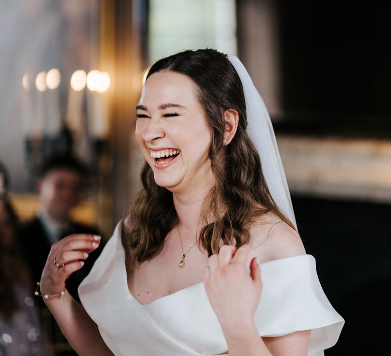 Bride smiles joyfully as she wears Eva Lendel wedding gown 