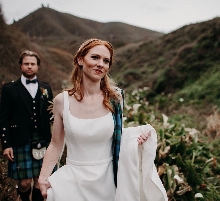 Beautiful bride with ginger hair in a princess wedding dress with natural wedding makeup and half up half down wedding hairstyle 