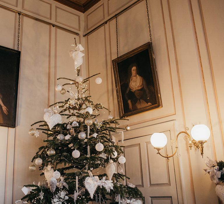 Christmas tree decorated with silver theme complete with white ribbon 