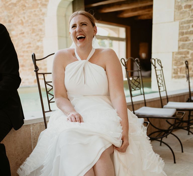 Bride shows off her bright pink pointed Jimmy Choo heels with diamanté ankle strap