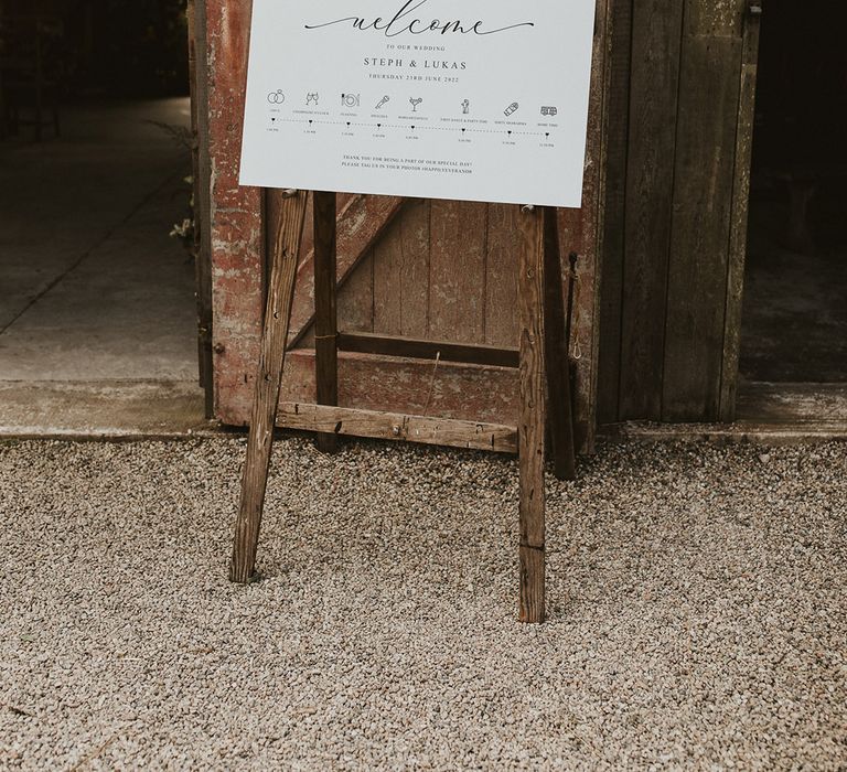 Simple and minimal black and white wedding welcome and order of the day sign 