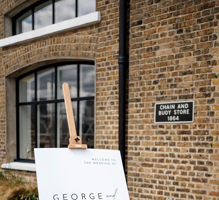 White wedding welcome signage with contemporary feel on wooden easel 