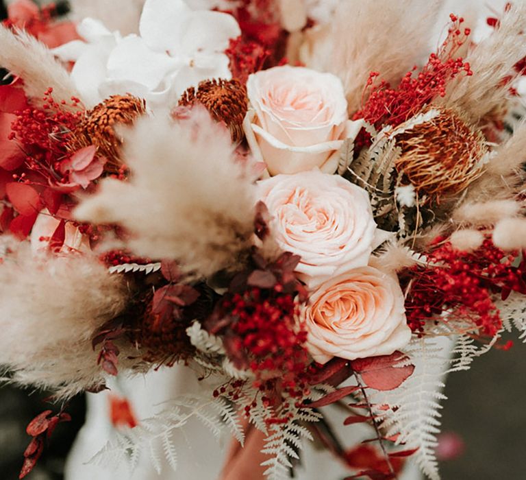 Pale pink and red wedding flower bouquet with pampas grass