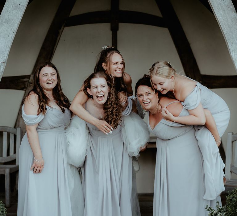 Bridesmaids in off the shoulder grey dresses with the bride off the shoulder flower wedding dress