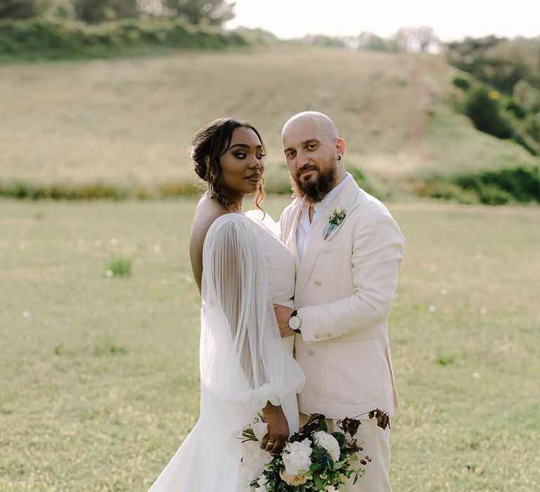 Bride and Groom in a field on the Italian coast at destination wedding