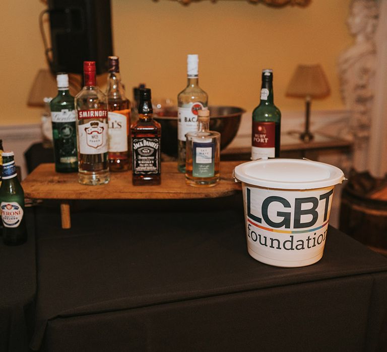 Wedding bar with white bucket for LGBTQ charity donations 